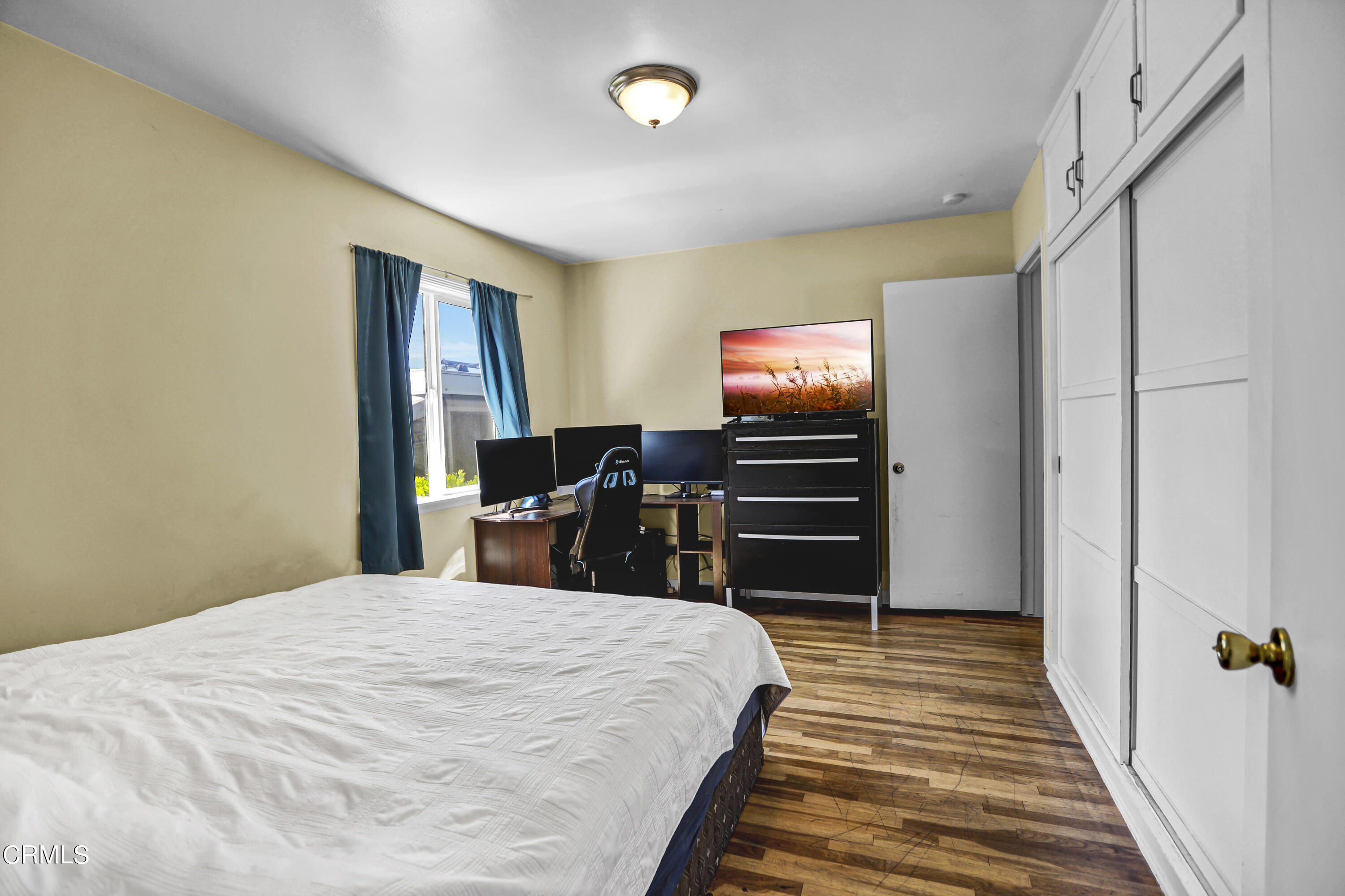 930 Doris Avenue Oxnard, CA 93030 - Photo 11 of 16 a bedroom with a bed and a flat screen tv