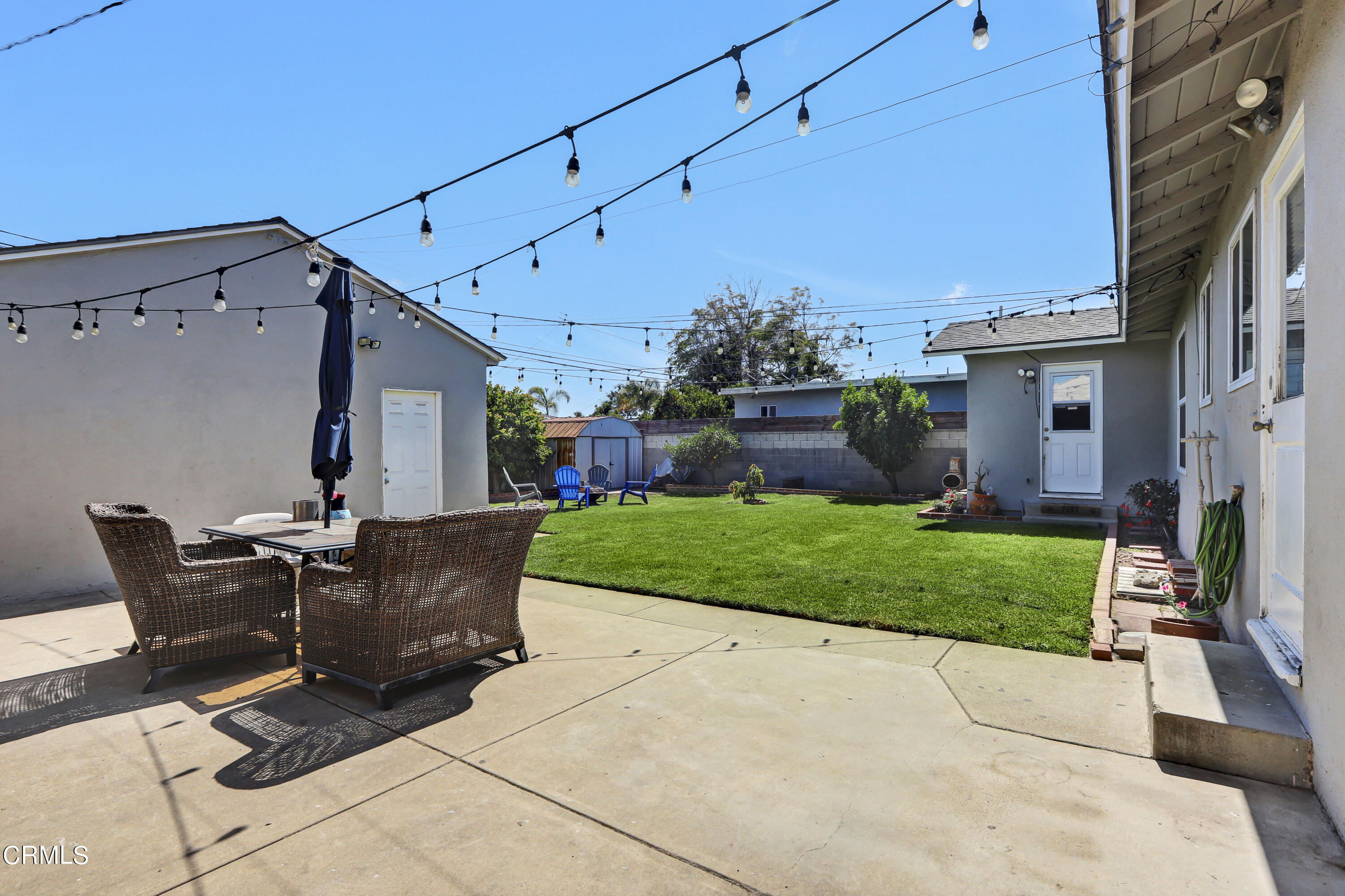 930 Doris Avenue Oxnard, CA 93030 - Photo 14 of 16 a view of a patio with table and chairs potted plants