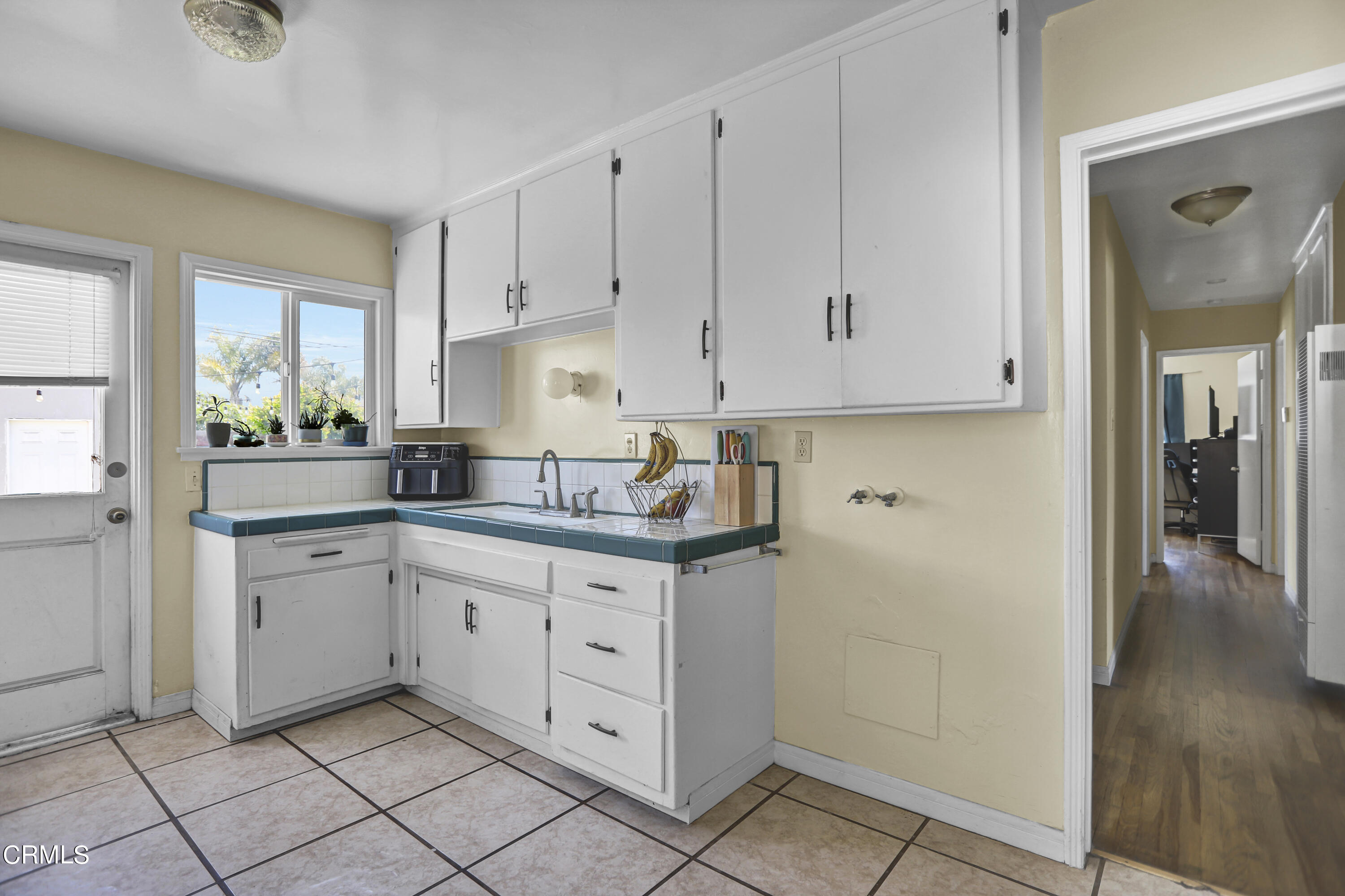 930 Doris Avenue Oxnard, CA 93030 - Photo 8 of 16 a kitchen with granite countertop white cabinets and white appliances