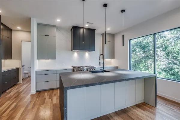 a view of a kitchen with wooden floor and a sink