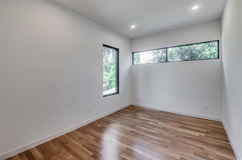 4525 Weldon Street Dallas, TX 75204 - Photo 16 of 40 an empty room with wooden floor and windows