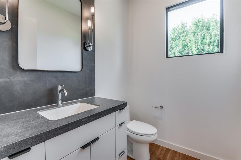 4525 Weldon Street Dallas, TX 75204 - Photo 17 of 40 a bathroom with a sink and a mirror