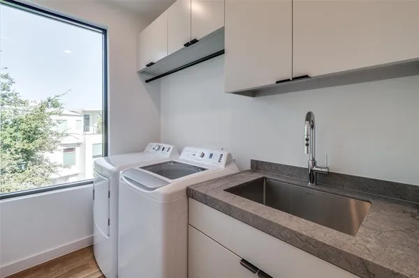 a kitchen with kitchen island a sink stainless steel appliances and cabinets