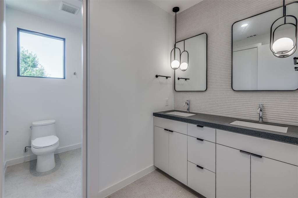 4525 Weldon Street Dallas, TX 75204 - Photo 21 of 40 a bathroom with a toilet sink and mirror