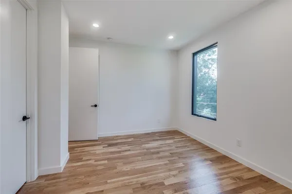 a view of hallway with wooden floor