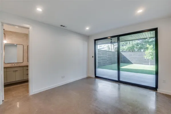 an empty room with floor to ceiling windows and an outdoor view