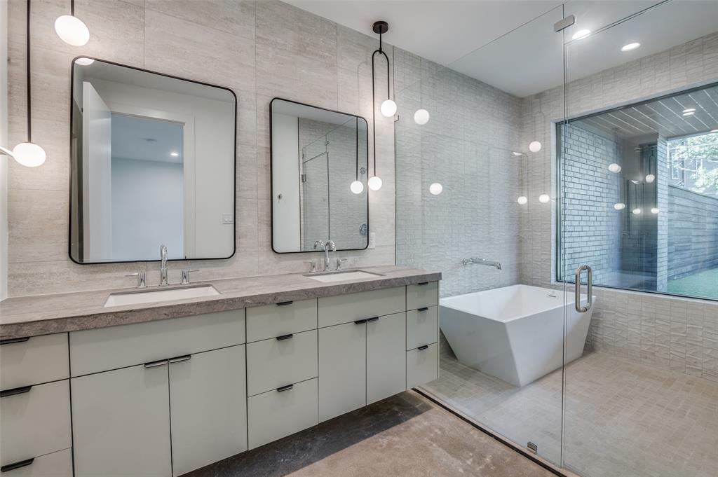 4525 Weldon Street Dallas, TX 75204 - Photo 4 of 40 a spacious bathroom with a double vanity sink mirror and bathtub