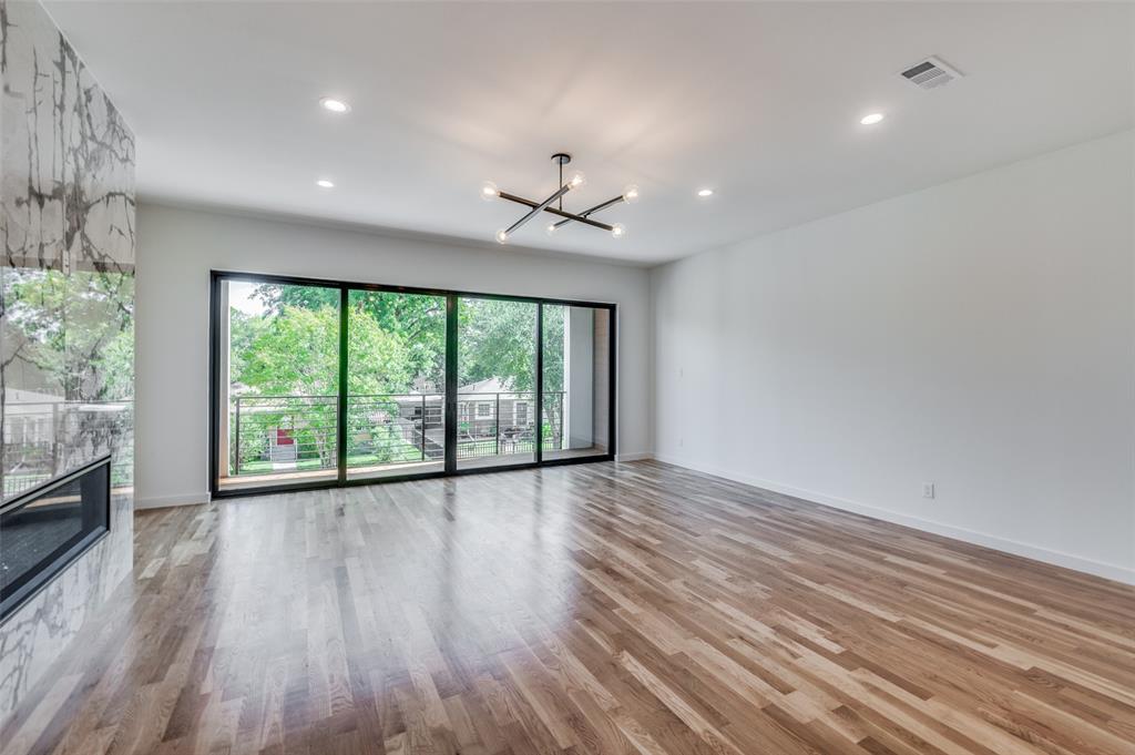 4525 Weldon Street Dallas, TX 75204 - Photo 6 of 40 an empty room with wooden floor and windows