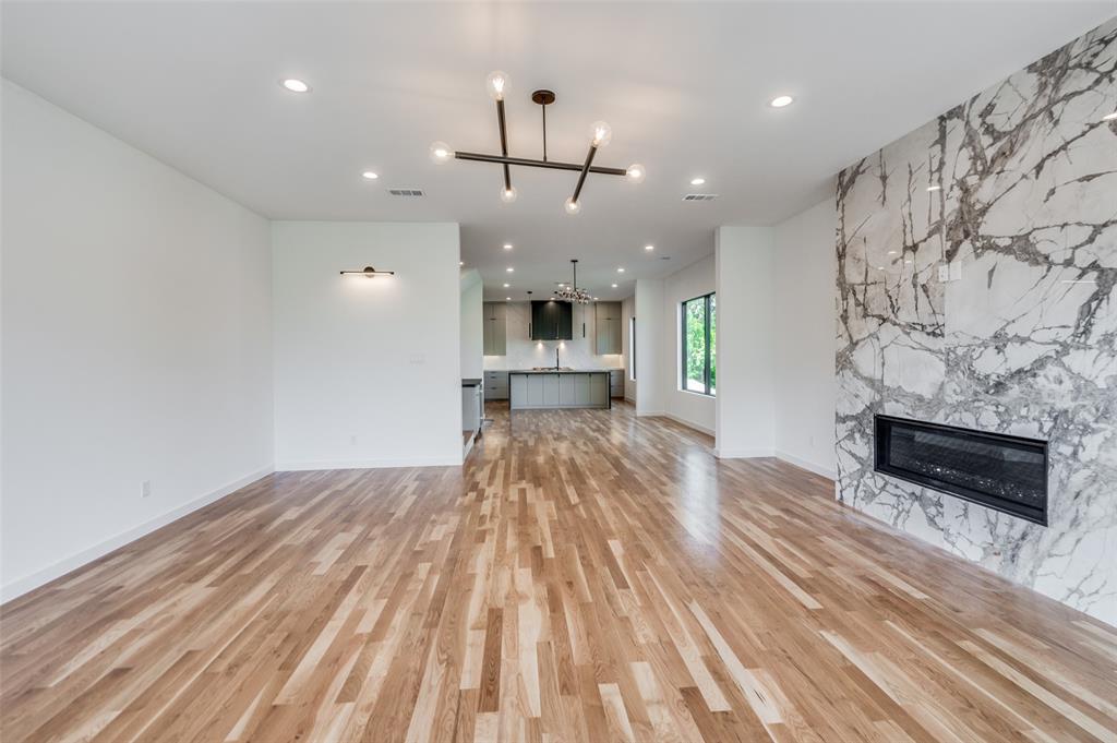 4525 Weldon Street Dallas, TX 75204 - Photo 9 of 40 wooden floor in an empty room with a fireplace