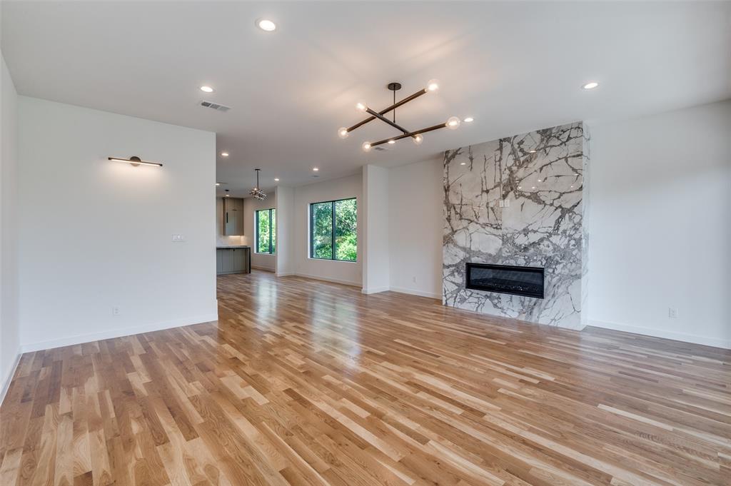 4525 Weldon Street Dallas, TX 75204 - Photo 10 of 40 a view of empty room with wooden floor and fireplace
