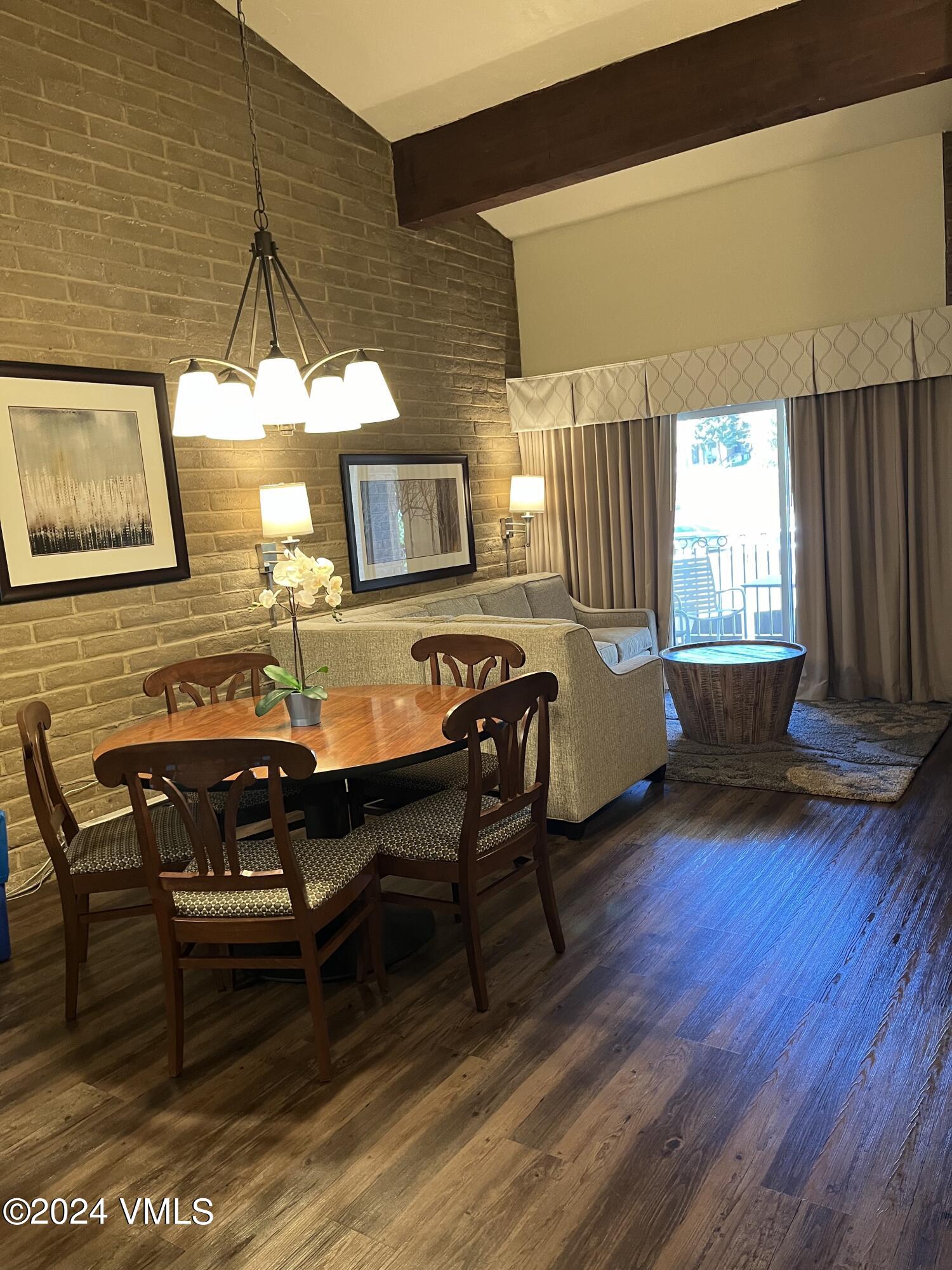1020 Vail View Drive, Unit 141139 Vail, CO 81657 - Photo 2 of 20 a living room with furniture a dining table and wooden floor