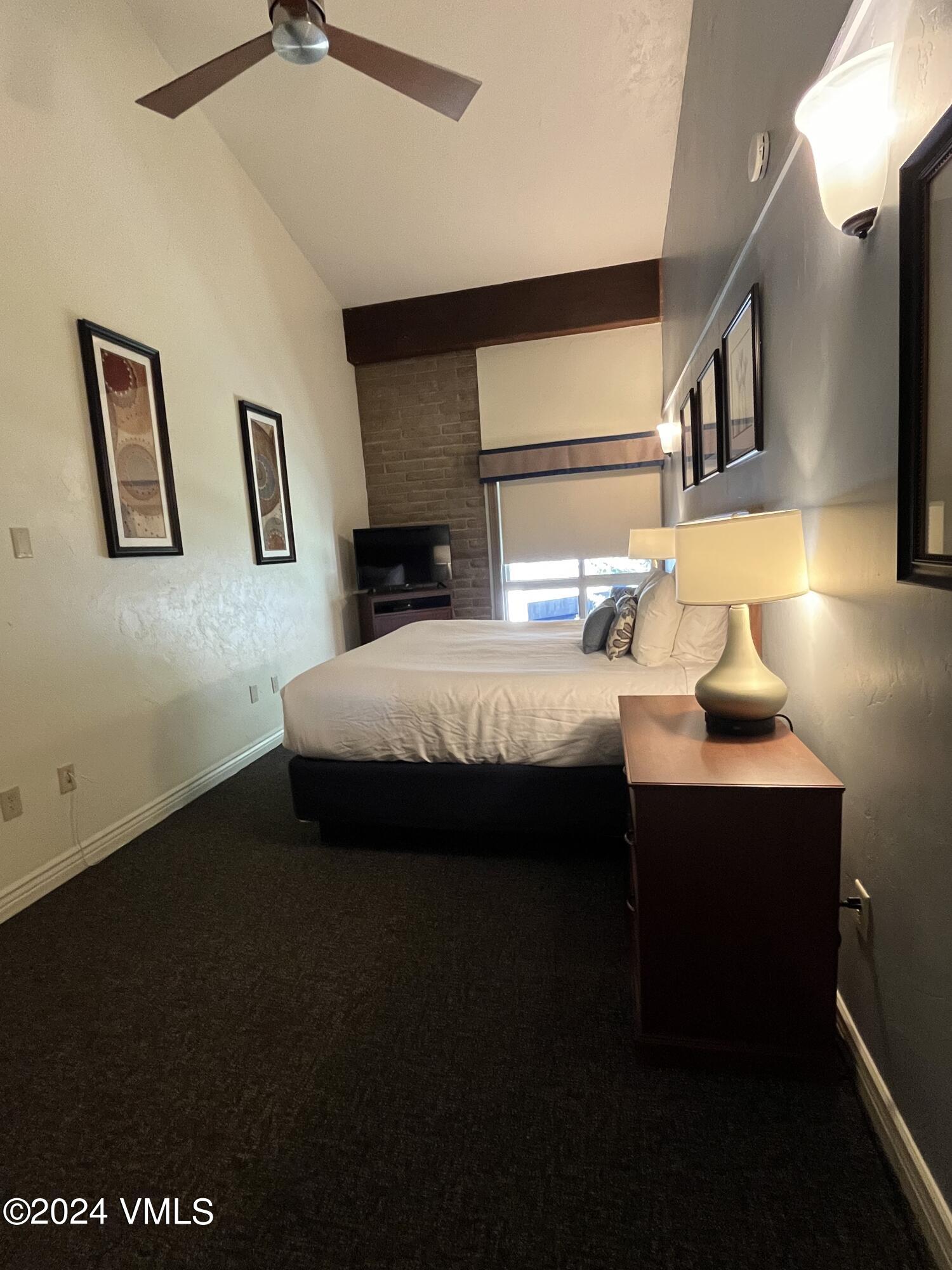 1020 Vail View Drive, Unit 141139 Vail, CO 81657 - Photo 5 of 20 a bedroom with a bed and a night stand