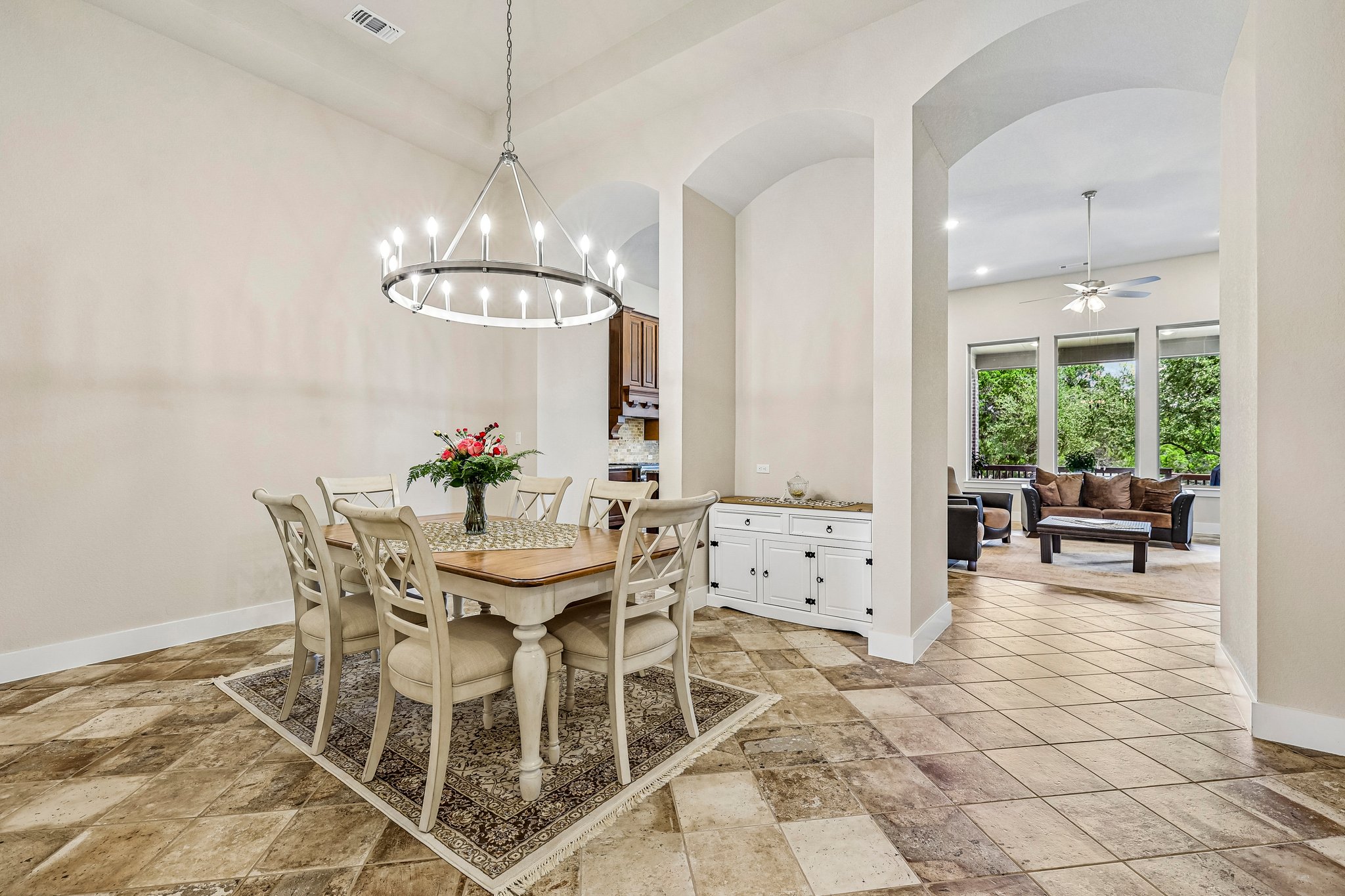 1705 Parten Rnch Parkway Austin, TX 78737 - Photo 9 of 39 An open dining area with arched doorways seamlessly flows into an adjoining living space.