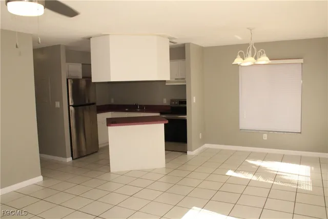 a kitchen with a sink cabinets and appliances