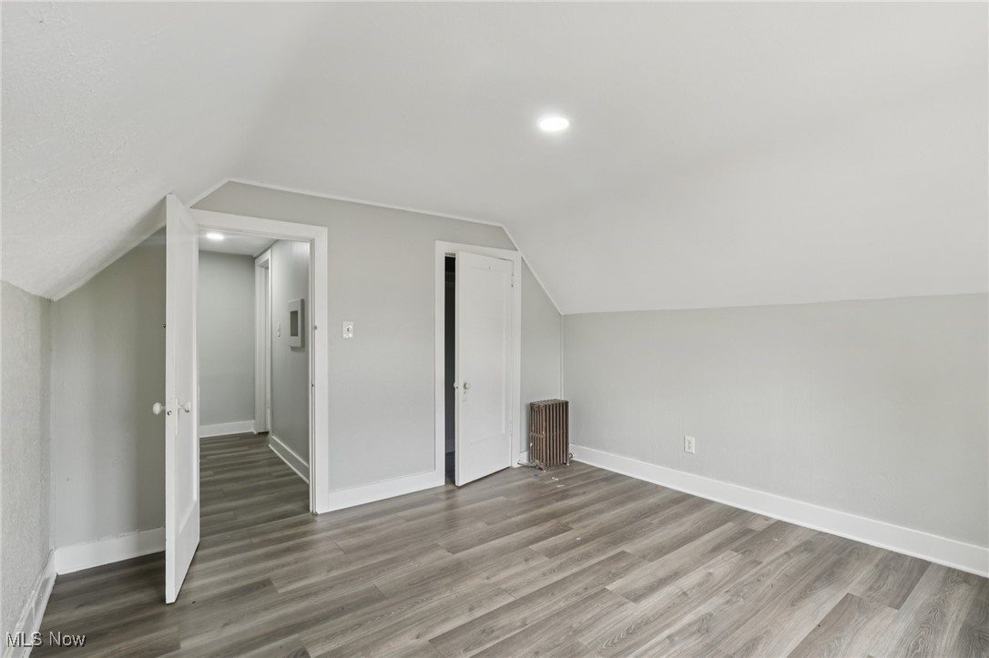 748 Chalker Street Akron, OH 44310 - Photo 25 of 48 Bonus room featuring lofted ceiling, wood finished floors, radiator heating unit, and recessed lighting