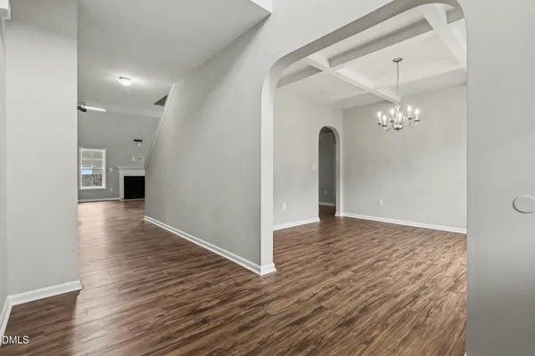 a view of a livingroom with a ceiling fan and wooden floor