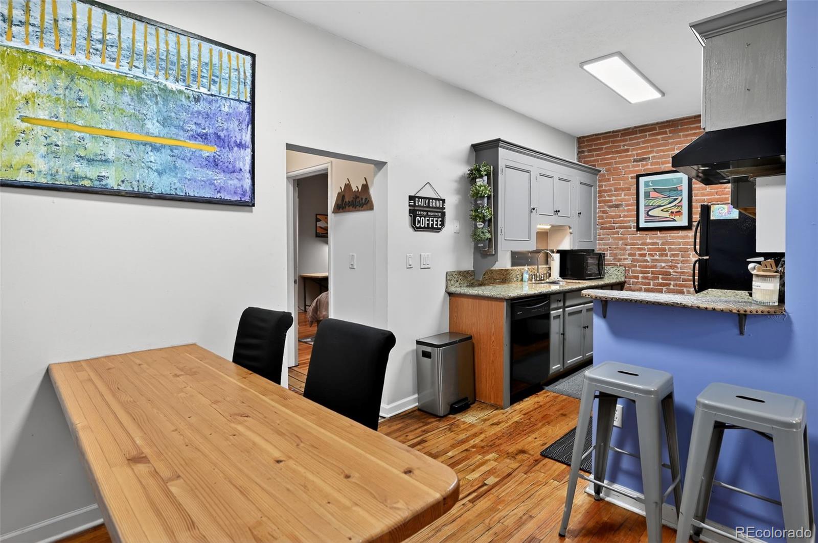 1608 Miner Street, Unit 2 Idaho Springs, CO 80452 - Photo 11 of 35 a bedroom with a bed and wooden floor