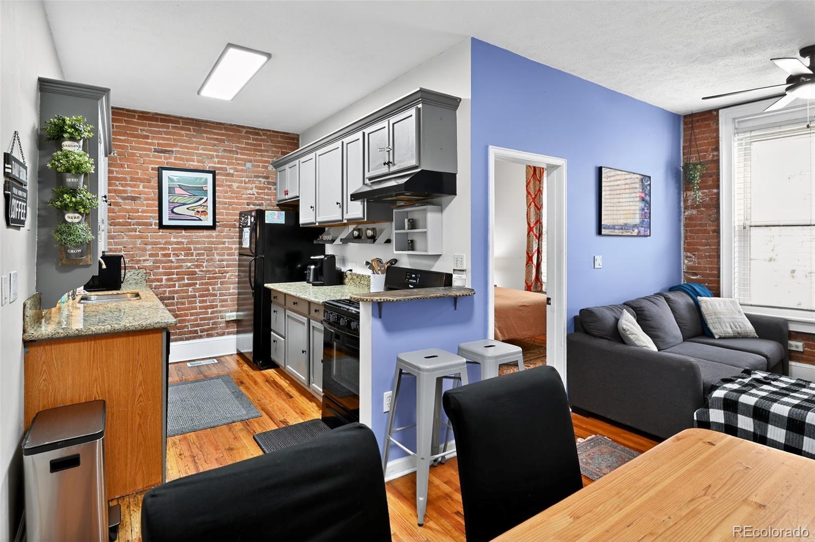 1608 Miner Street, Unit 2 Idaho Springs, CO 80452 - Photo 15 of 35 a living room with furniture kitchen view and a window