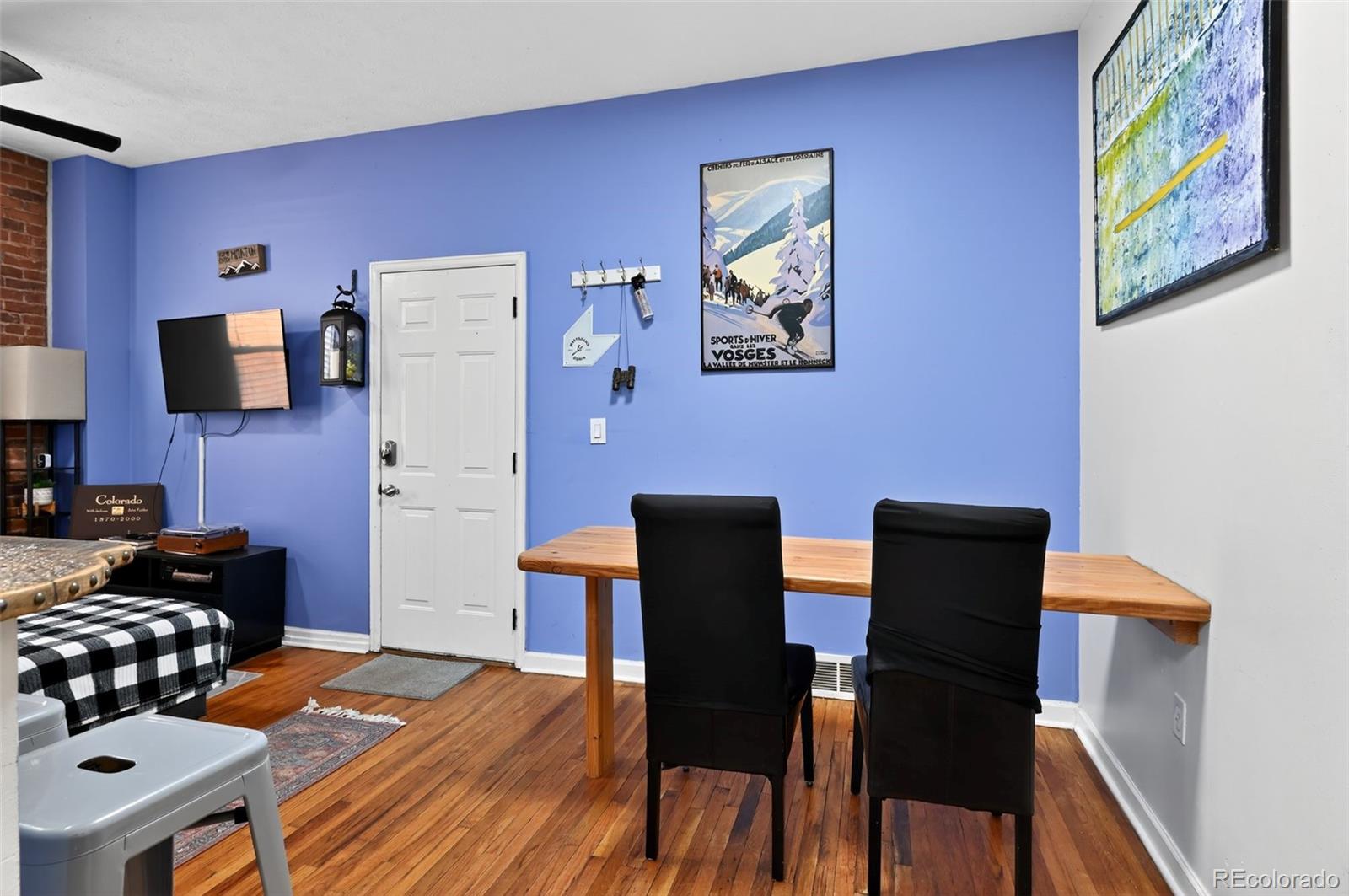 1608 Miner Street, Unit 2 Idaho Springs, CO 80452 - Photo 18 of 35 a kitchen with stainless steel appliances a dining table chairs and a refrigerator