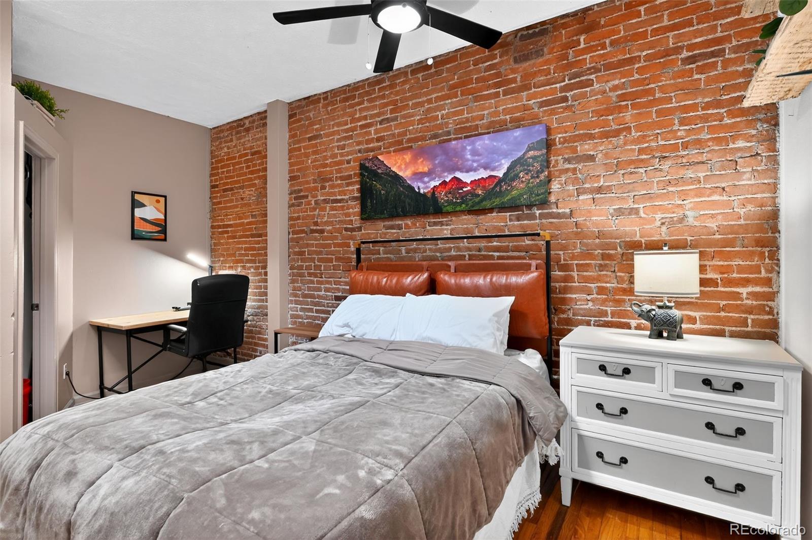 1608 Miner Street, Unit 2 Idaho Springs, CO 80452 - Photo 22 of 35 a bedroom with a bed and a flat screen tv