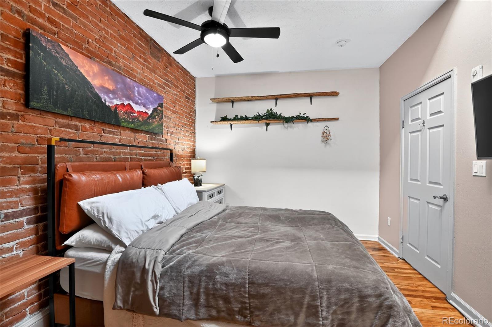 1608 Miner Street, Unit 2 Idaho Springs, CO 80452 - Photo 24 of 35 a bedroom with a bed and a painting on the wall