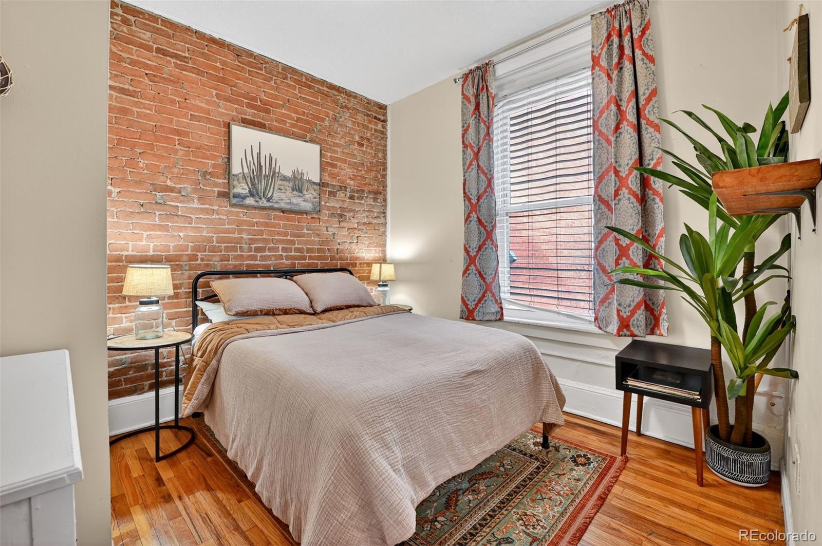 1608 Miner Street, Unit 2 Idaho Springs, CO 80452 - Photo 27 of 35 a bedroom with a bed and a potted plant
