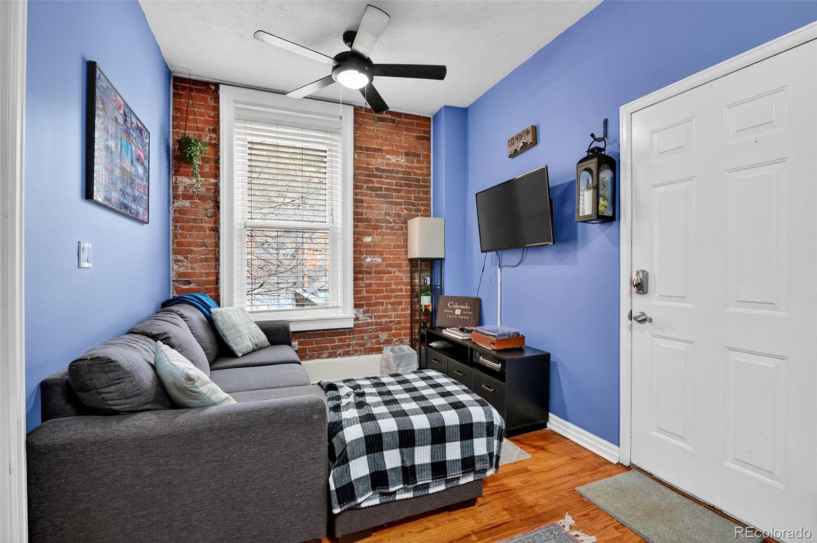 1608 Miner Street, Unit 2 Idaho Springs, CO 80452 - Photo 8 of 35 a bedroom with furniture and a flat screen tv