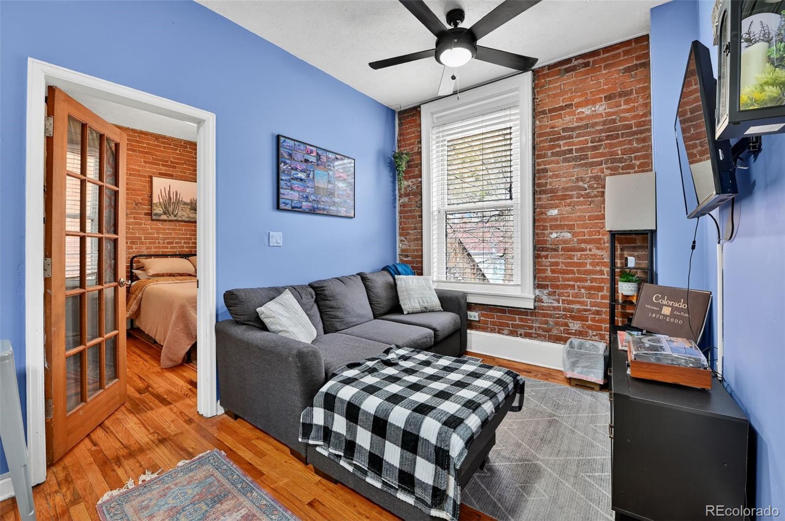 1608 Miner Street, Unit 2 Idaho Springs, CO 80452 - Photo 9 of 35 a living room with furniture a flat screen tv and a window