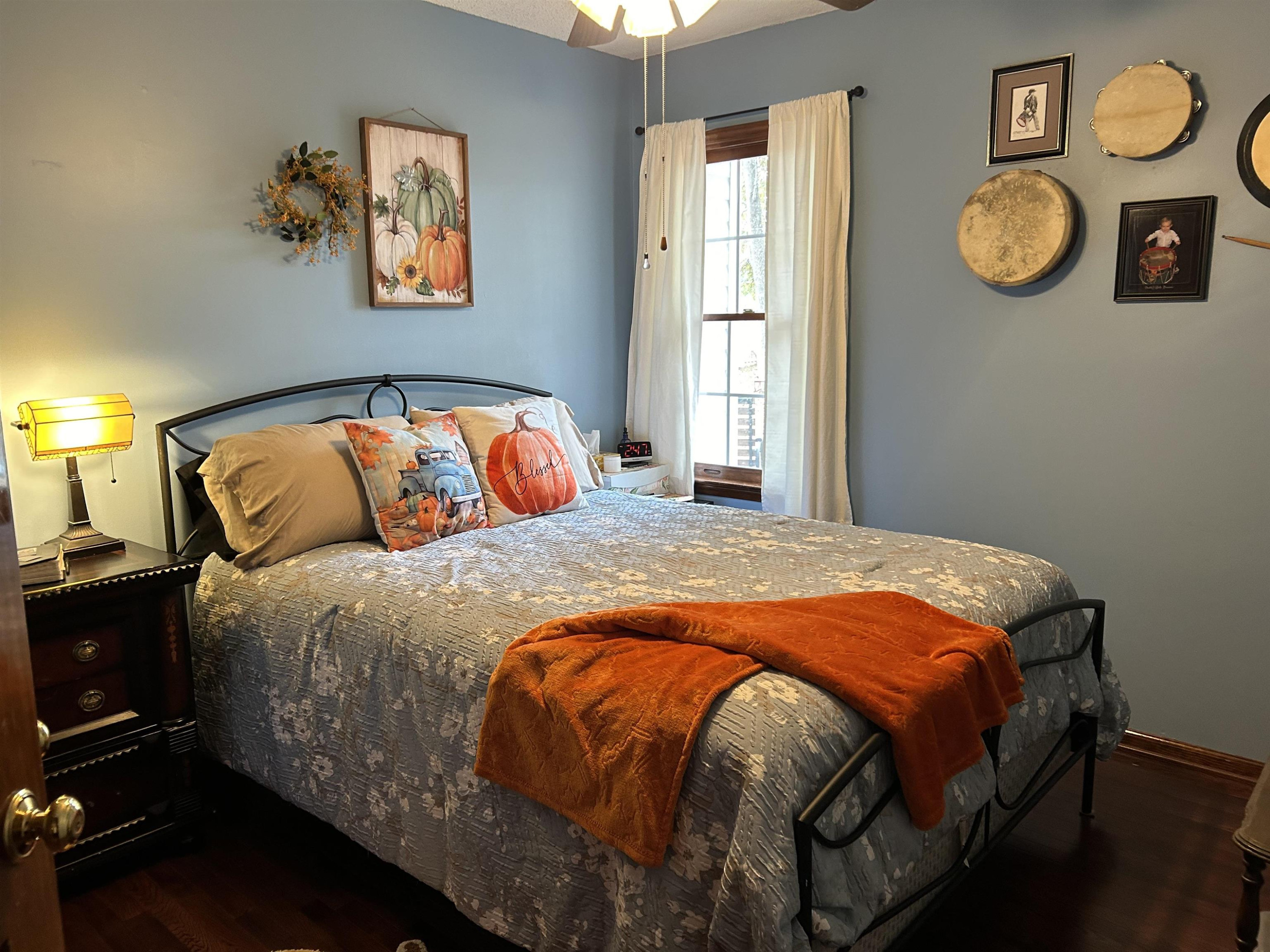 91 Violet Lane Coats, NC 27521 - Photo 15 of 19 a bedroom with a bed and painting on the wall