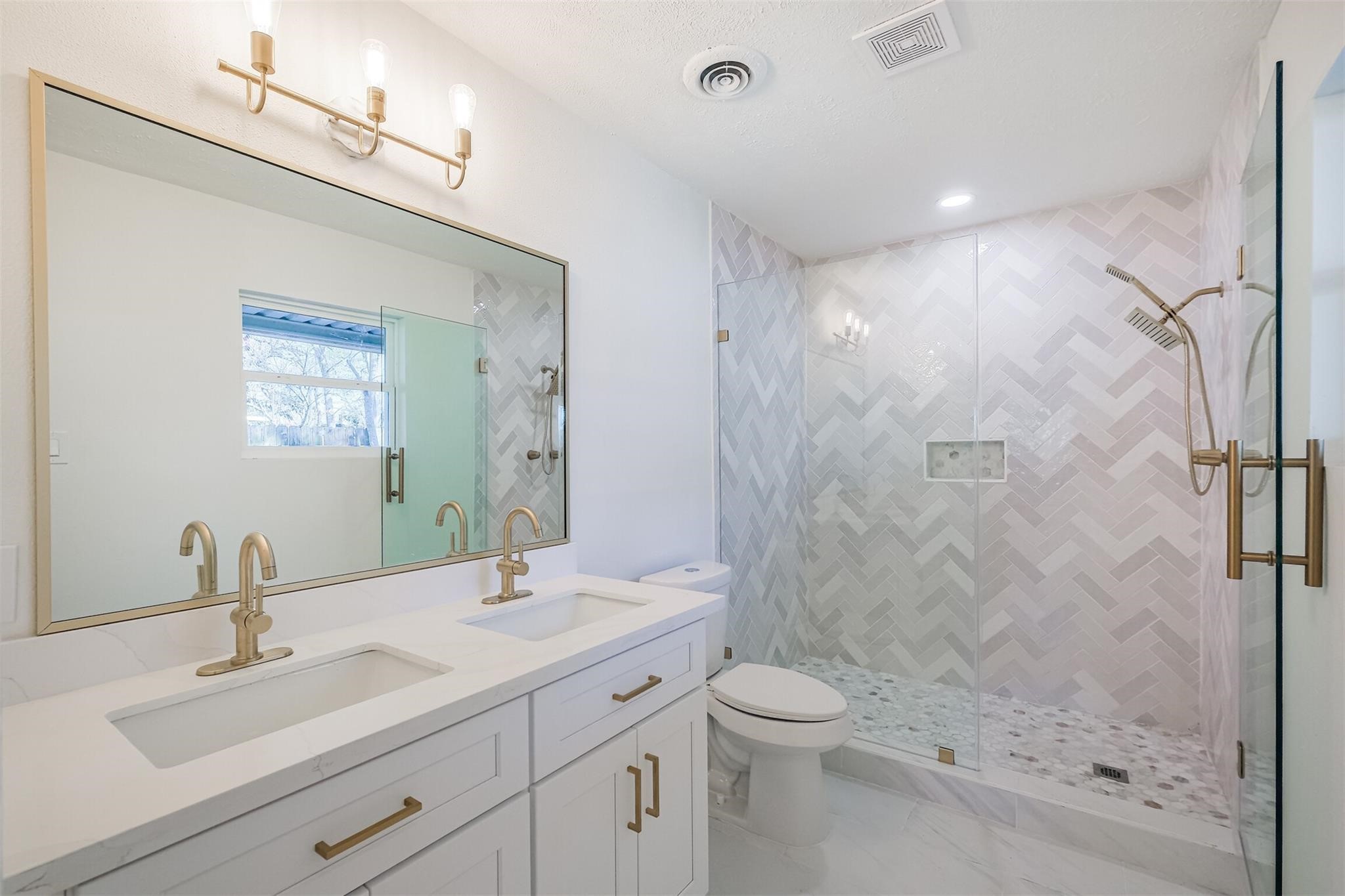 9419 Campbell Road Houston, TX 77080 - Photo 11 of 29 a bathroom with a shower sink vanity mirror and toilet