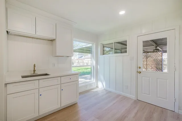 a kitchen with a sink cabinets and a window