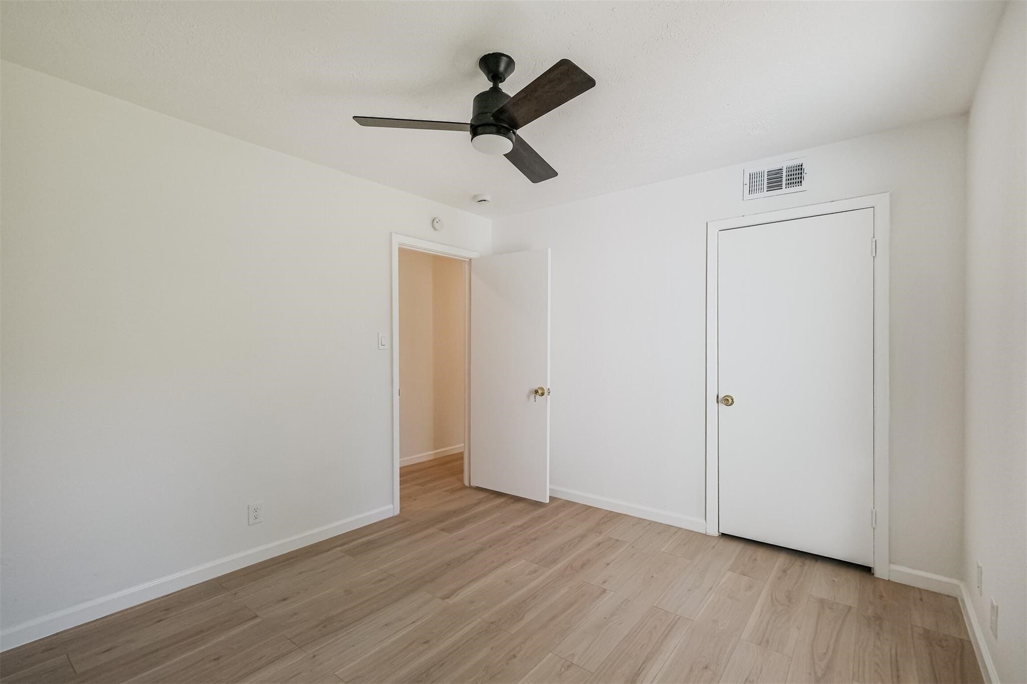 9419 Campbell Road Houston, TX 77080 - Photo 19 of 29 a view of empty room with wooden floor