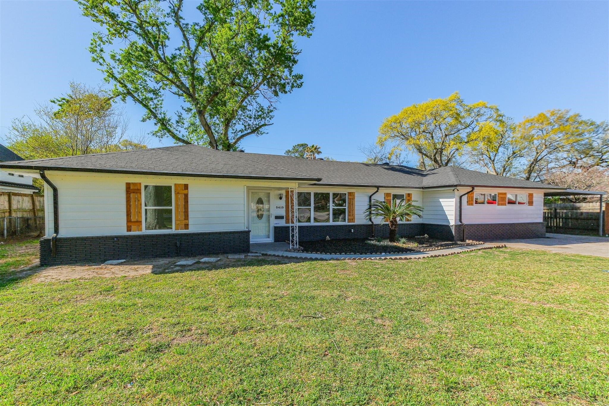 9419 Campbell Road Houston, TX 77080 - Photo 2 of 29 a front view of a house with a garden and swimming pool