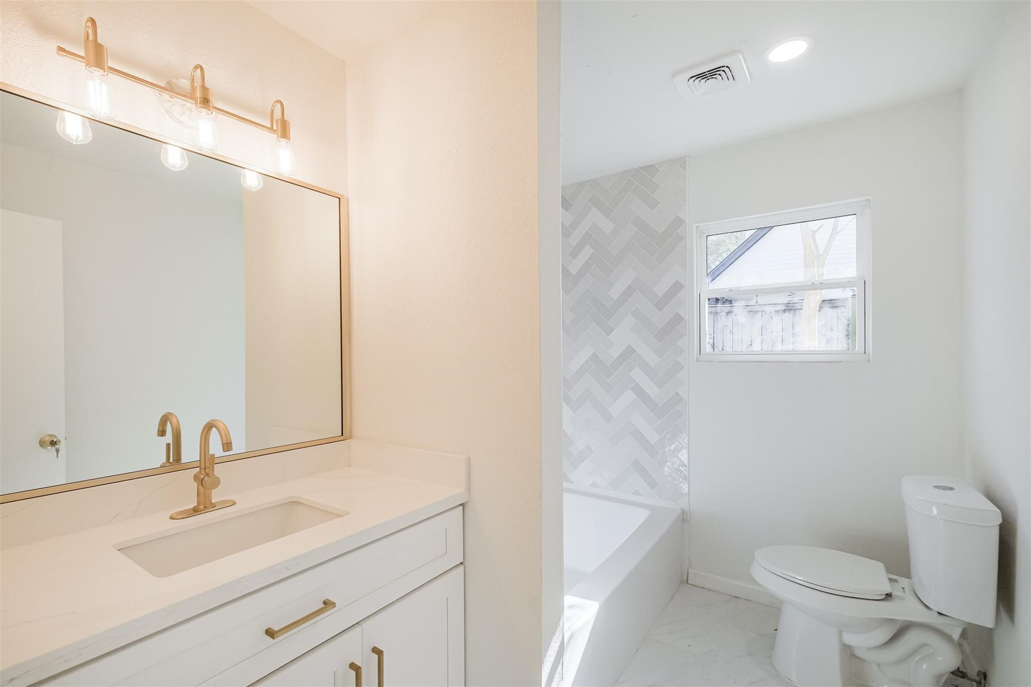 9419 Campbell Road Houston, TX 77080 - Photo 22 of 29 a bathroom with a sink a toilet and a mirror