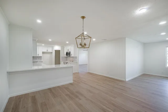 a view of a kitchen with wooden floor and a sink