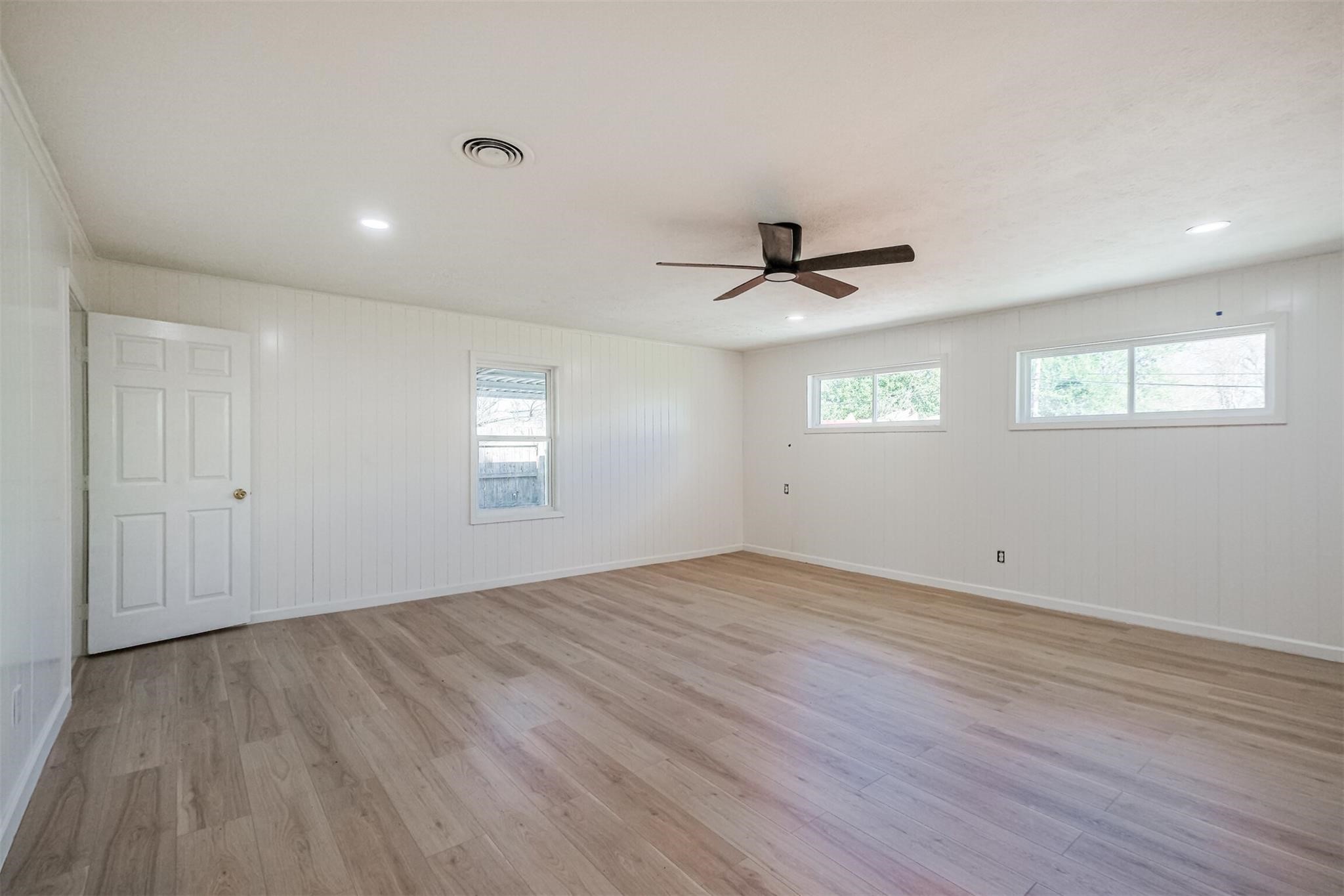 9419 Campbell Road Houston, TX 77080 - Photo 9 of 29 a view of empty room with wooden floor and fan