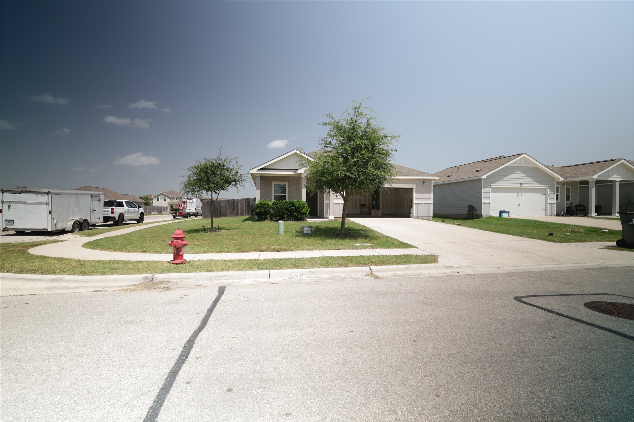 250 Seneca Loop Kyle, TX 78640 - Photo 18 of 22 A welcoming driveway leads to this charming residential home on a clear day.