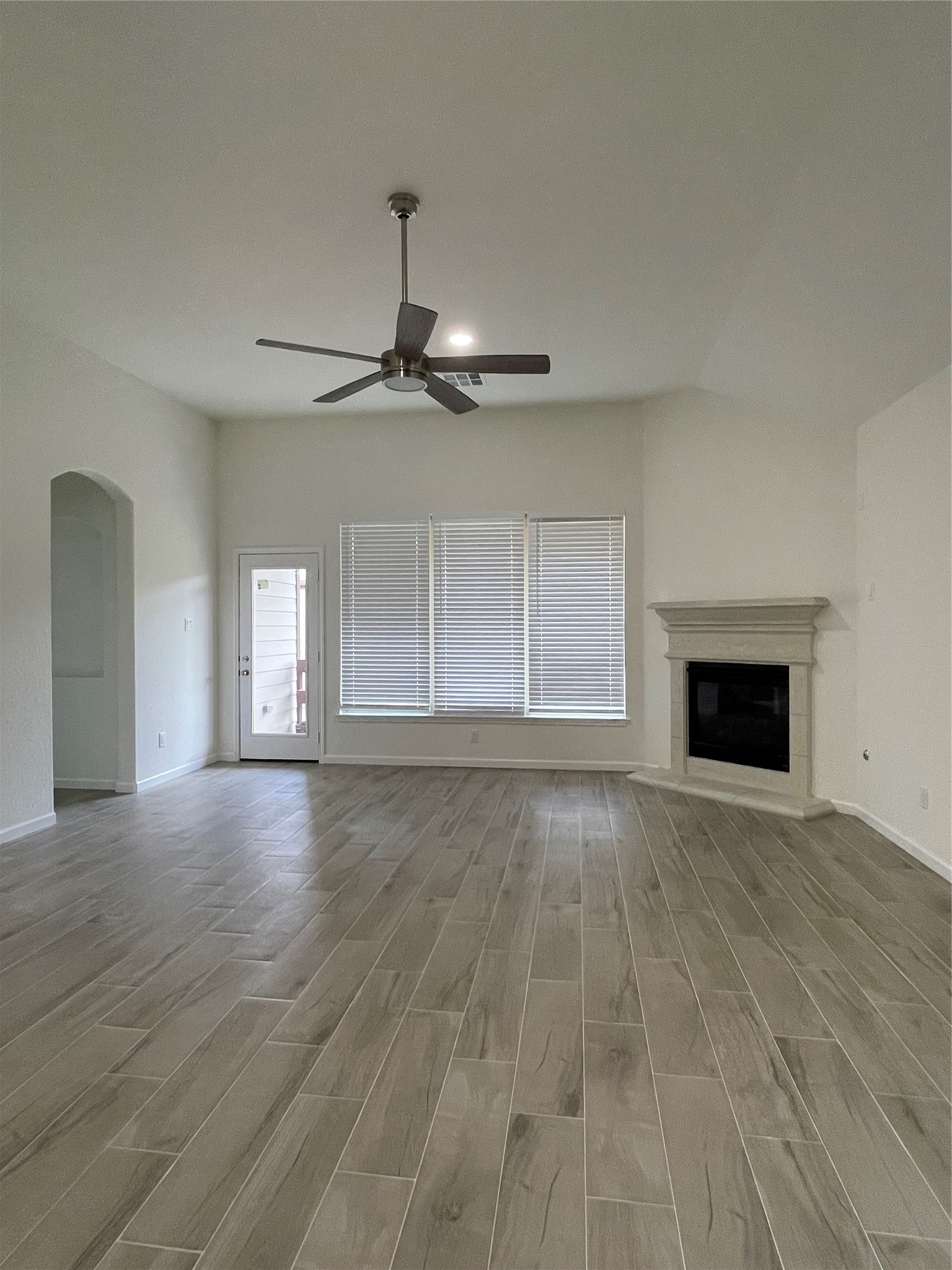 4118 Guild Meadows Drive Houston, TX 77084 - Photo 22 of 35 a view of an empty room with a fireplace and a window