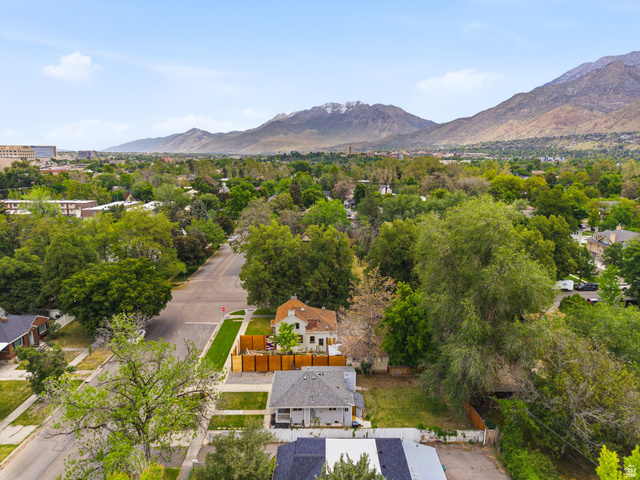 225 South 300 East Provo, UT 84606 - Photo 26 of 30 Aerial perspective showcasing mountainous terrain, surrounding cityscape, mature trees, and residential streets