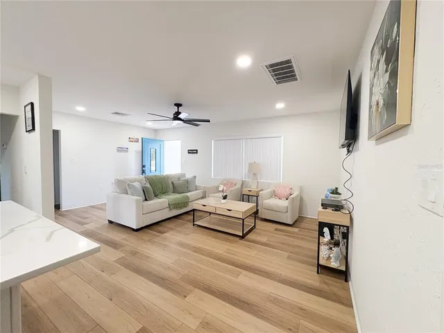 a living room with furniture and a chandelier