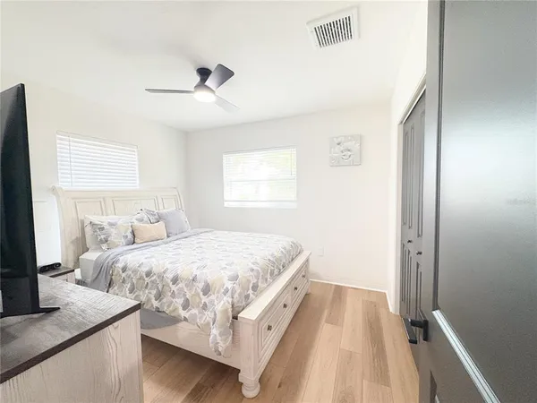 a bedroom with a bed and a flat screen tv