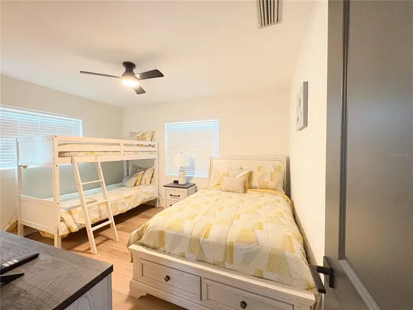 a bedroom with a bed and wooden floor