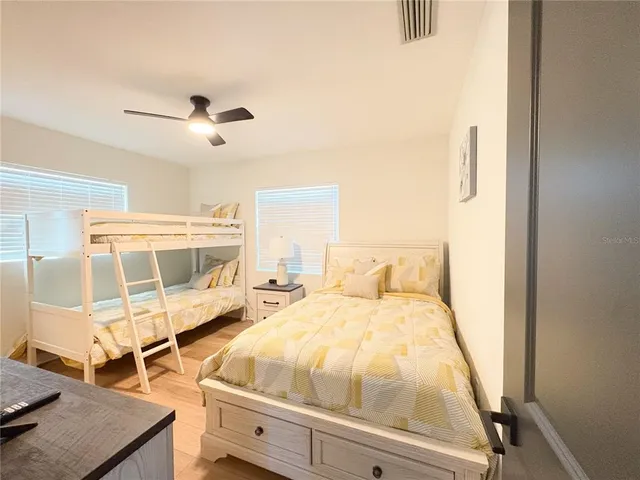 a bedroom with a bed and wooden floor