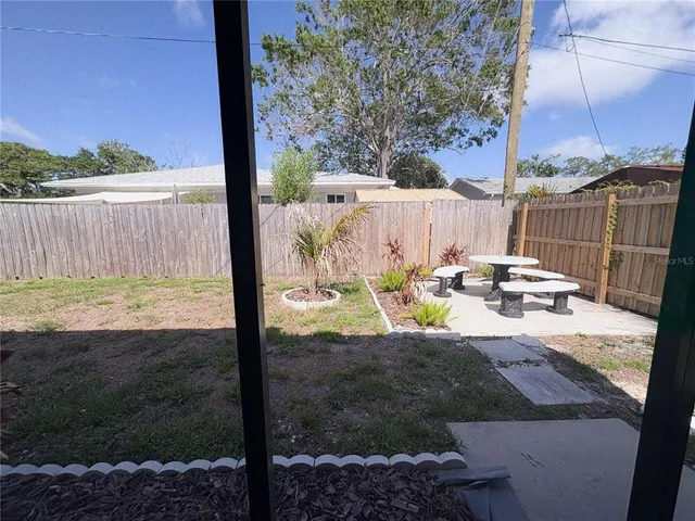 a view of a backyard with sitting area