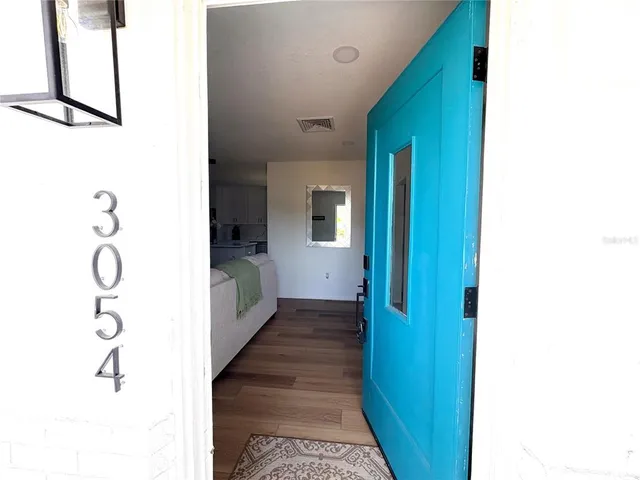 a view of a hallway with wooden floor