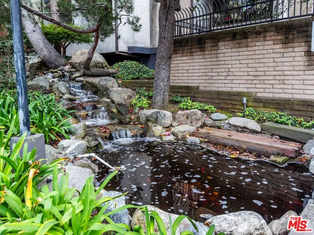 a view of a house with a flower garden