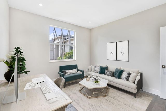 a living room with furniture and a potted plant