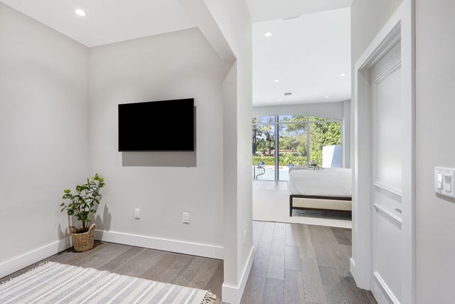 a view of a livingroom with wooden floor and furniture