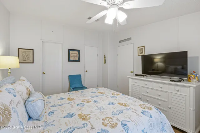 a bedroom with a large bed and a flat screen tv