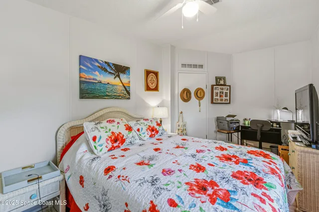 a bedroom with bed and paintings on the wall